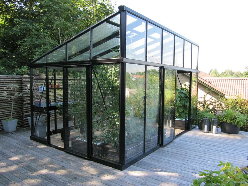 Janssens Modern Glass Greenhouse in a backyard