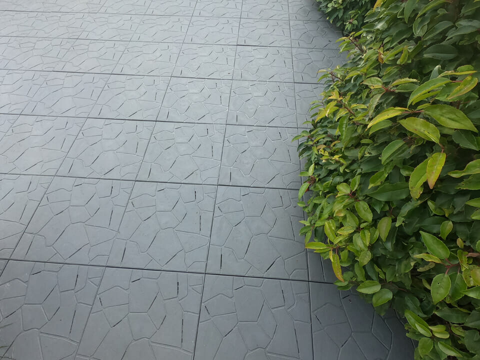 RSI Interlocking Greenhouse Flooring installed tile, gray, with stone effect