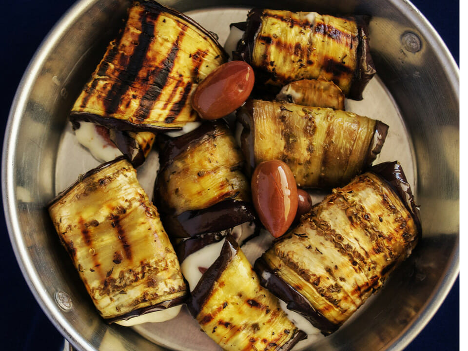 Grilled eggplant with grape tomatoes in bowl