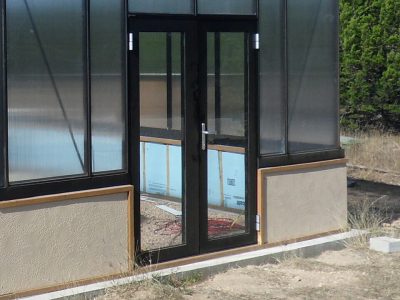 Double hinged doors installed on a Janssens Royal Victorian Greenhouse