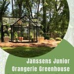 Janssens Junior Orangerie glass greenhouse with black frame on level surface in landscape