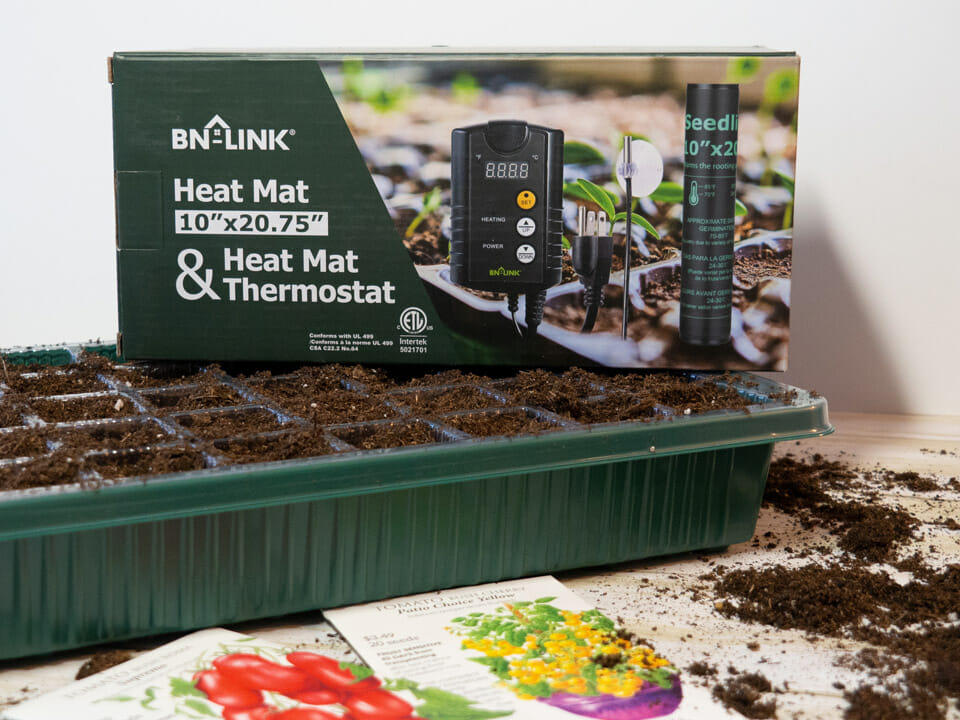 BNLink Heat Mat with thermostat on top of seed tray with seed packets and soil