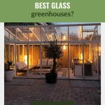 External image of glass greenhouse, lighted from within with seating area inside greenhouse