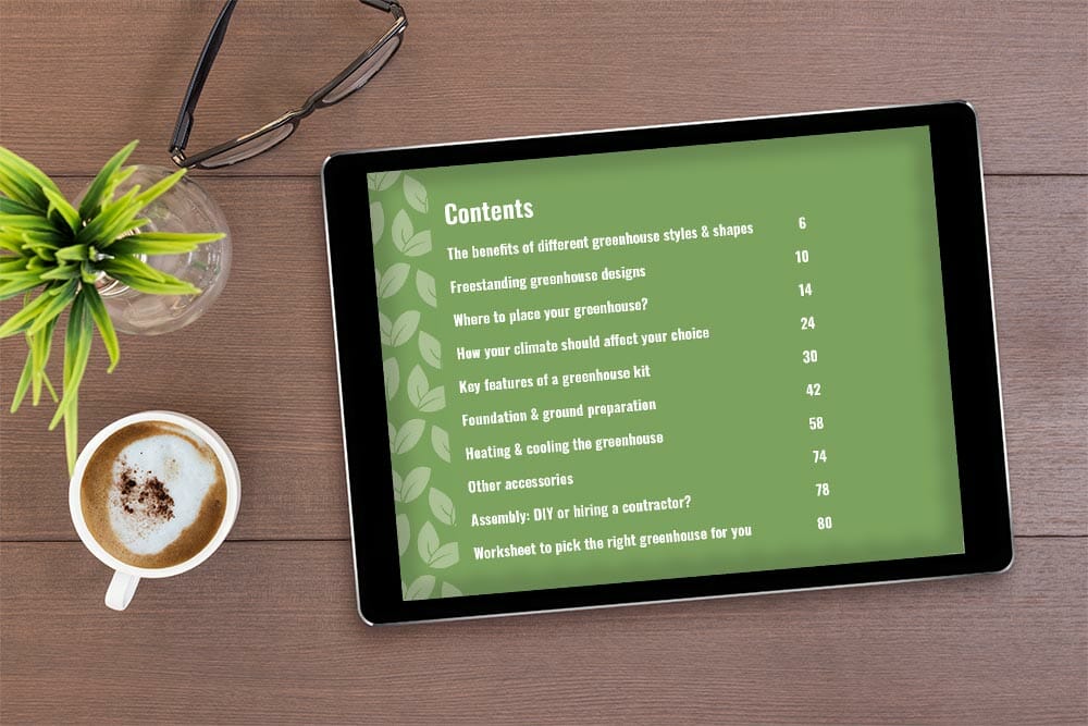Tablet on a wooden table with plant and coffee, document on tablet is a page of the eBook: Your Greenhouse, Your Choice - A Practical Guide To Picking Your Greenhouse Kit