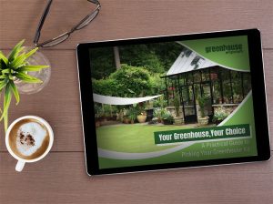 Tablet on a table with plant, coffee, and glasses, on the table is the cover of the eBook: Your Greenhouse, Your Choice - A Practical Guide To Picking Your Greenhouse Kit