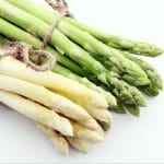 Green Asparagus and White Asparagus with the text: Can I Grow Asparagus in a Greenhouse?