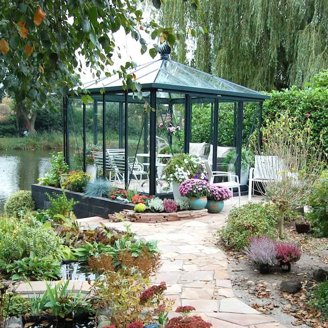 Glass greenhouse with square footprint and high gutters