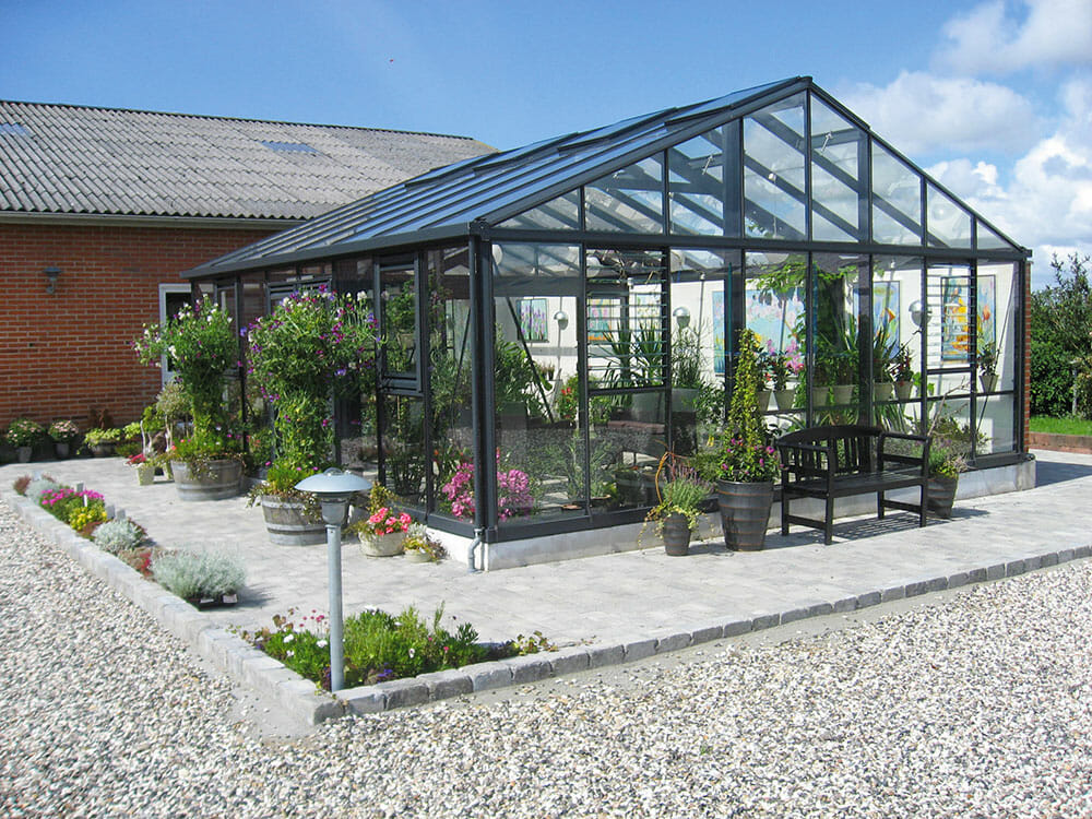 Janssens Gigant greenhouse - large glass greenhouse in front of house