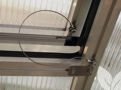 Wire on Riga roof window wind restraint system