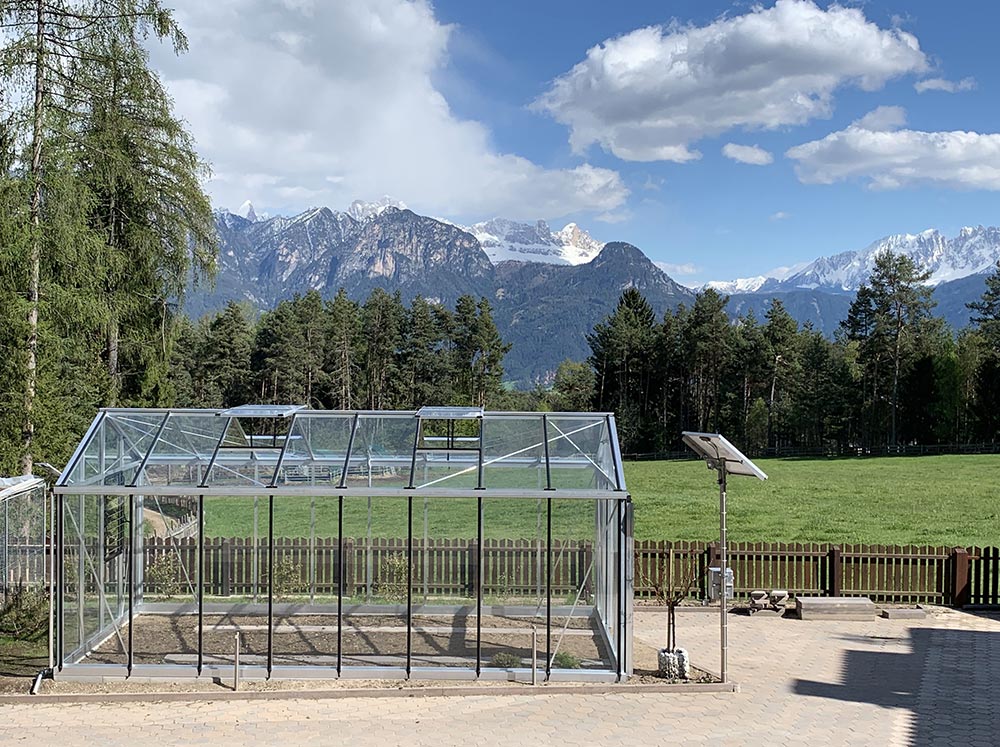 Exaco Janssens Royal Victorian VI36 Greenhouse set up with mountain range in the background