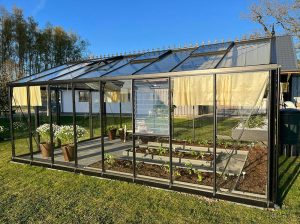 Side view of an Exaco Janssens Royal Victorian VI46 Greenhouse with garden beds