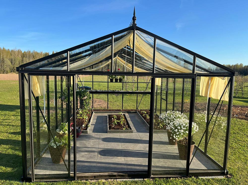 Front view of an Exaco Janssens Royal Victorian VI46 Greenhouse with garden beds
