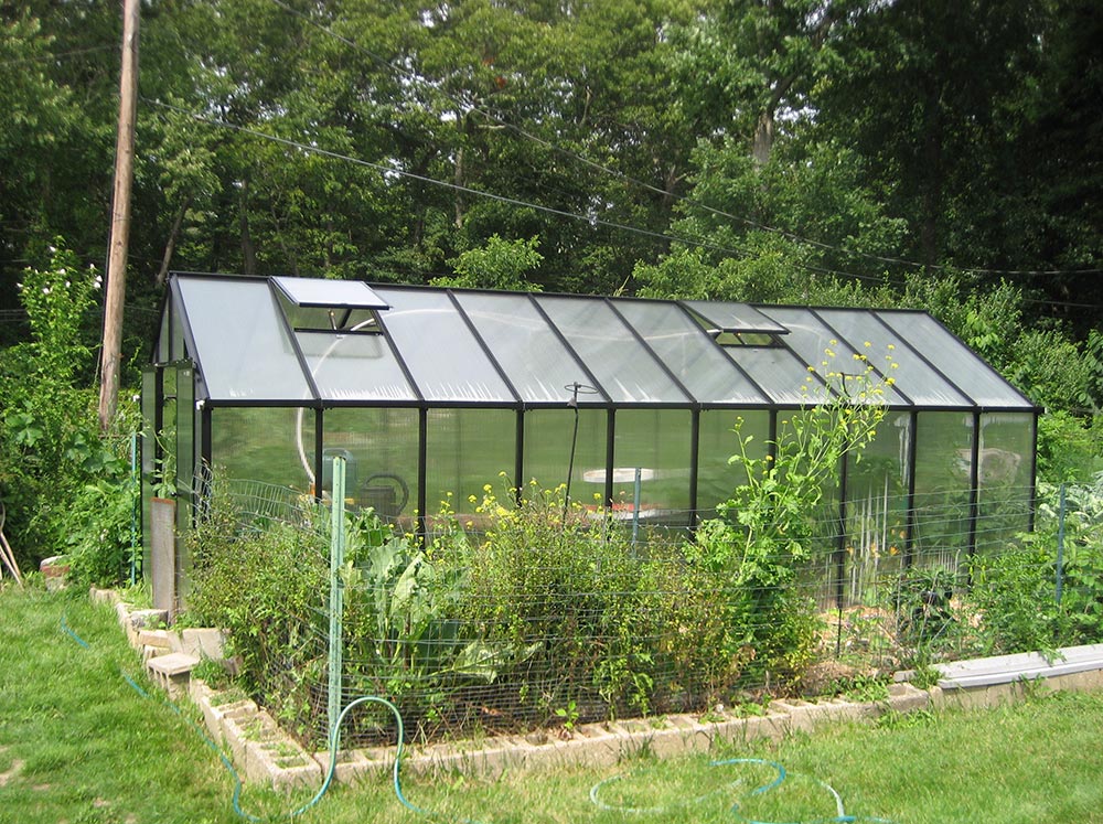 Side view of Riverstone MONT Greenhouse 8x20 in garden