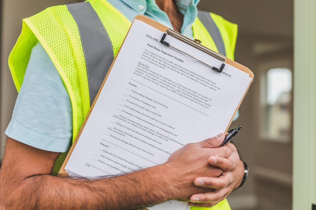 Construction worker holding clipboard with permit for greenhouse