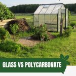 Greenhouse in field with text: Glass Vs Polycarbonate The Greenhouse Debate