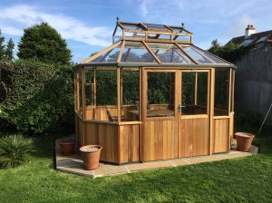 Alton Wooden Octagonal Greenhouse in a backyard