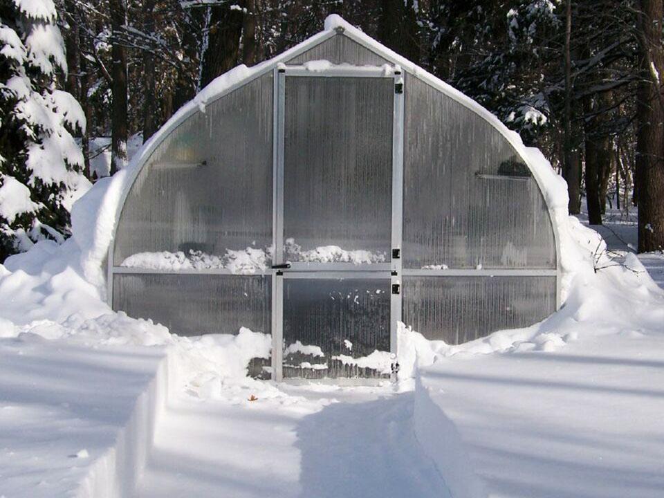 snow covered Riga greenhouse helps with heating solutions