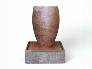 39" tall rust colored cigar fountain with rounded pillar and water spout in center of flat top, making water flow down the sides of pillar and into the square base. Made of high-strength glass-reinforced concrete, uses 396 GPH pump, and weighs 370 lbs, and includes 1 LED light.