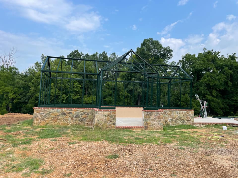 Janssens Victorian greenhouse on stem wall without glass. Using a kit you can build your own greenhouse.