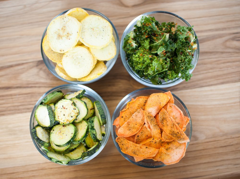 A top down perspective of four neatly placed mason jars filled with freeze dried vegetables.