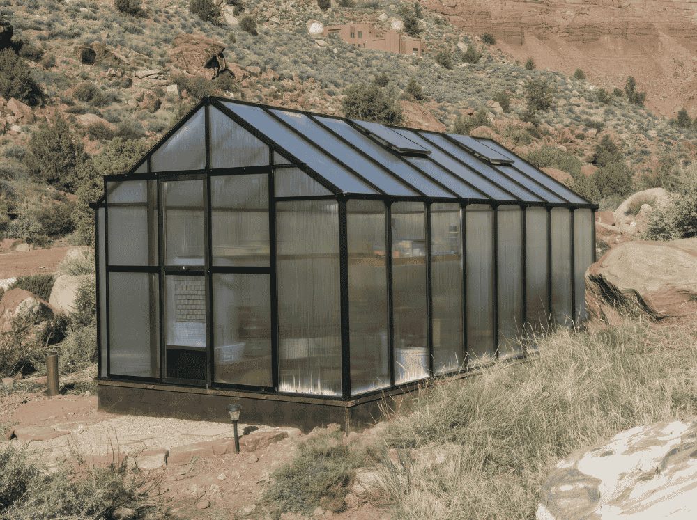 Large gable MONT Greenhouse set in a desert with concrete foundation.