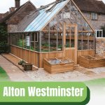 Exterior of an Alton Westminster greenhouse attached to a house with a graphic at the bottom reading "Alton Westminster Cedar Greenhouse" and the Greenhouse Emporium logo in the bottom right corner.
