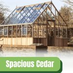 Exterior of an Alton Westminster greenhouse with a graphic at the bottom reading "Spacious Cedar Greenhouse For Enthusiasts" and the Greenhouse Emporium logo in the bottom right corner.