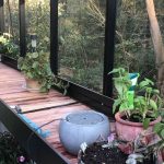 Wooden built in shelf with a few potted plants
