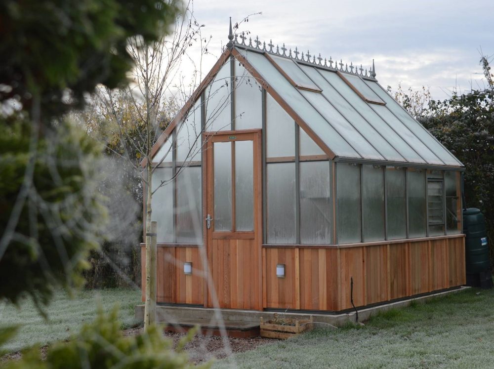 Wooden Alton Gable greenhouse with glass panels frosted over.