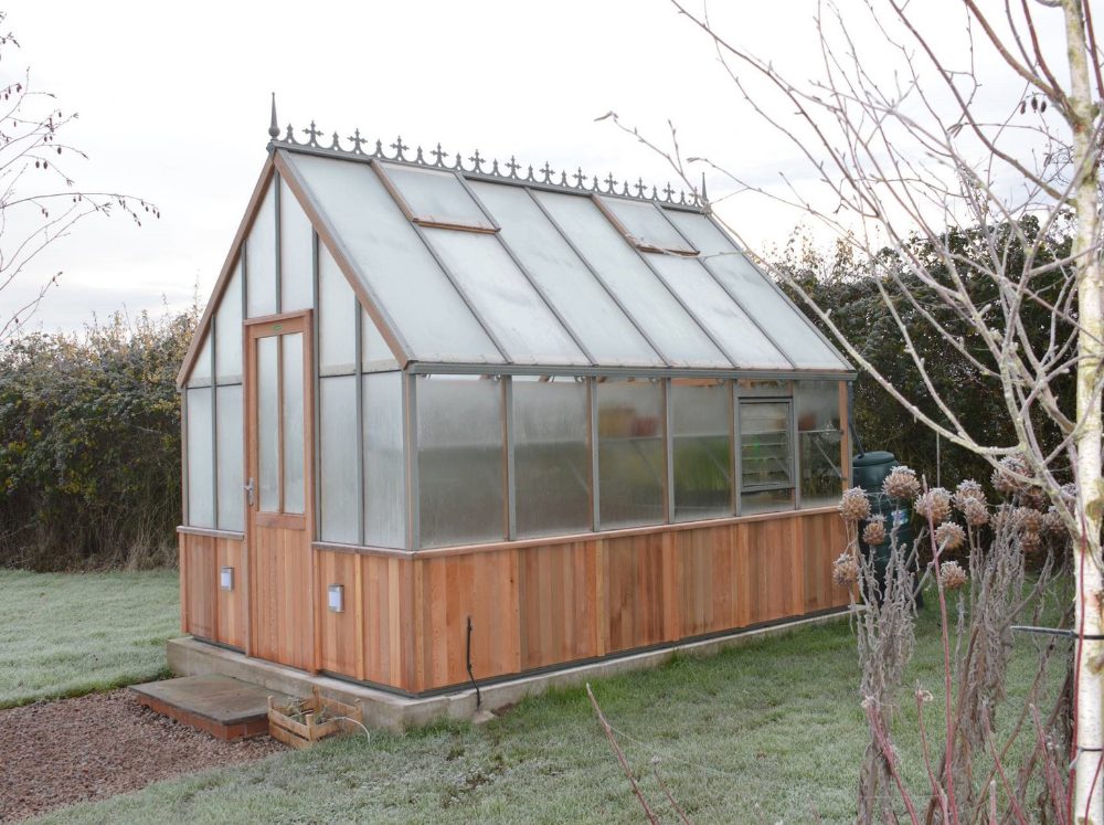 Exterior of an Alton wooden greenhouse with the foundation all cleaned up for winter. 