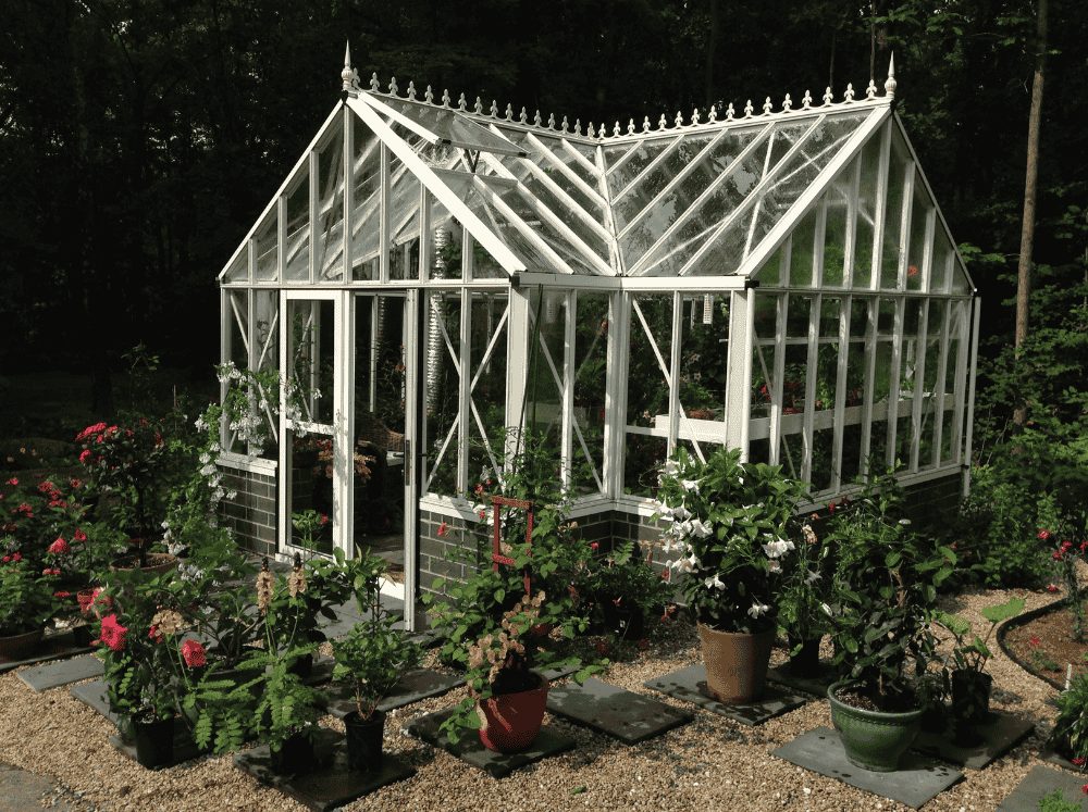 Exterior of a Janssens glass antique orangerie on a brick stem wall