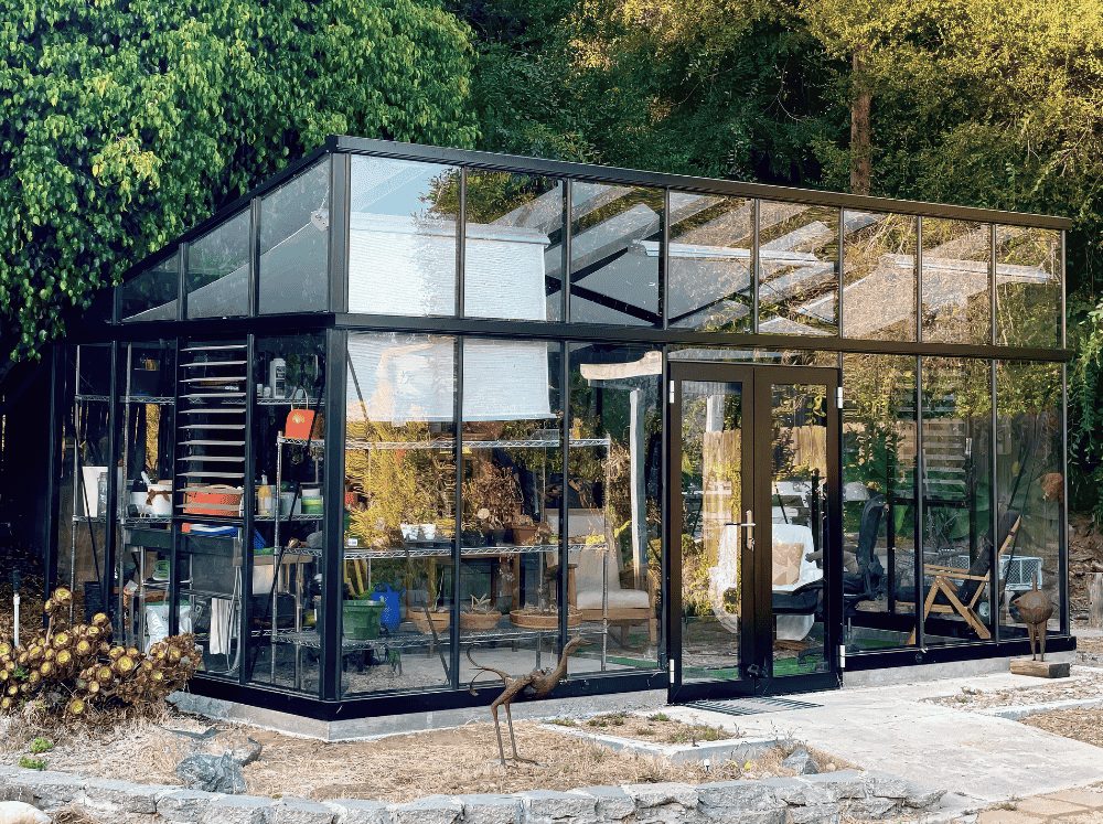 Front exterior view of a modern glass greenhouse