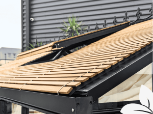Close up of exterior wood slatted greenhouse shade with a roof vent.