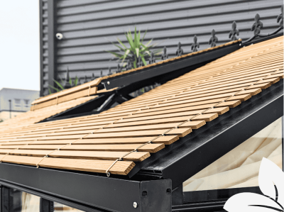 Close up of exterior wood slatted greenhouse shade with a roof vent.